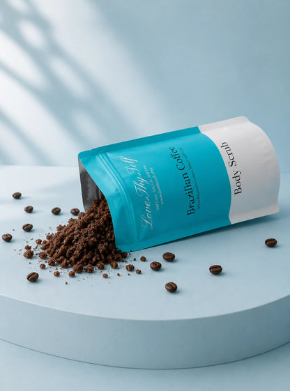 LoveThySelf Brazilian Coffee Body Scrub with exfoliating coffee scrub spilling from an open pouch, styled with whole coffee beans.