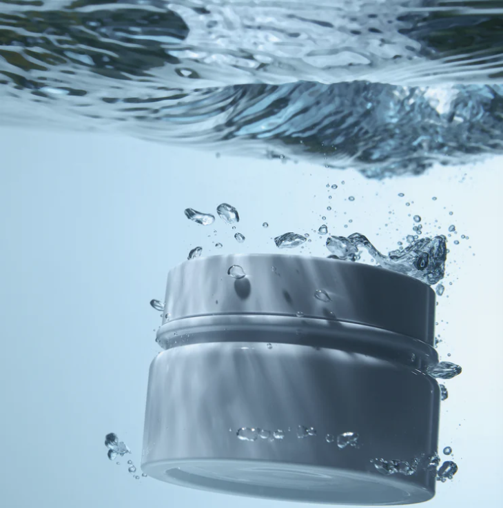 Hydrating skincare cream surrounded by water, representing LoveThySelf's commitment to clean, nourishing skincare