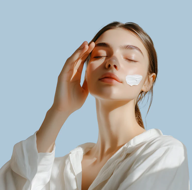 Woman applying skincare cream during a calming self-care ritual, reflecting the LoveThySelf brand story